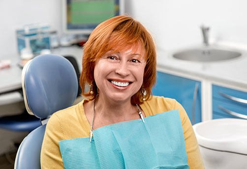 Middle aged lady siting on a dental chair