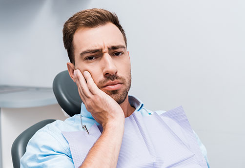 Man suffering from a tooth pain
